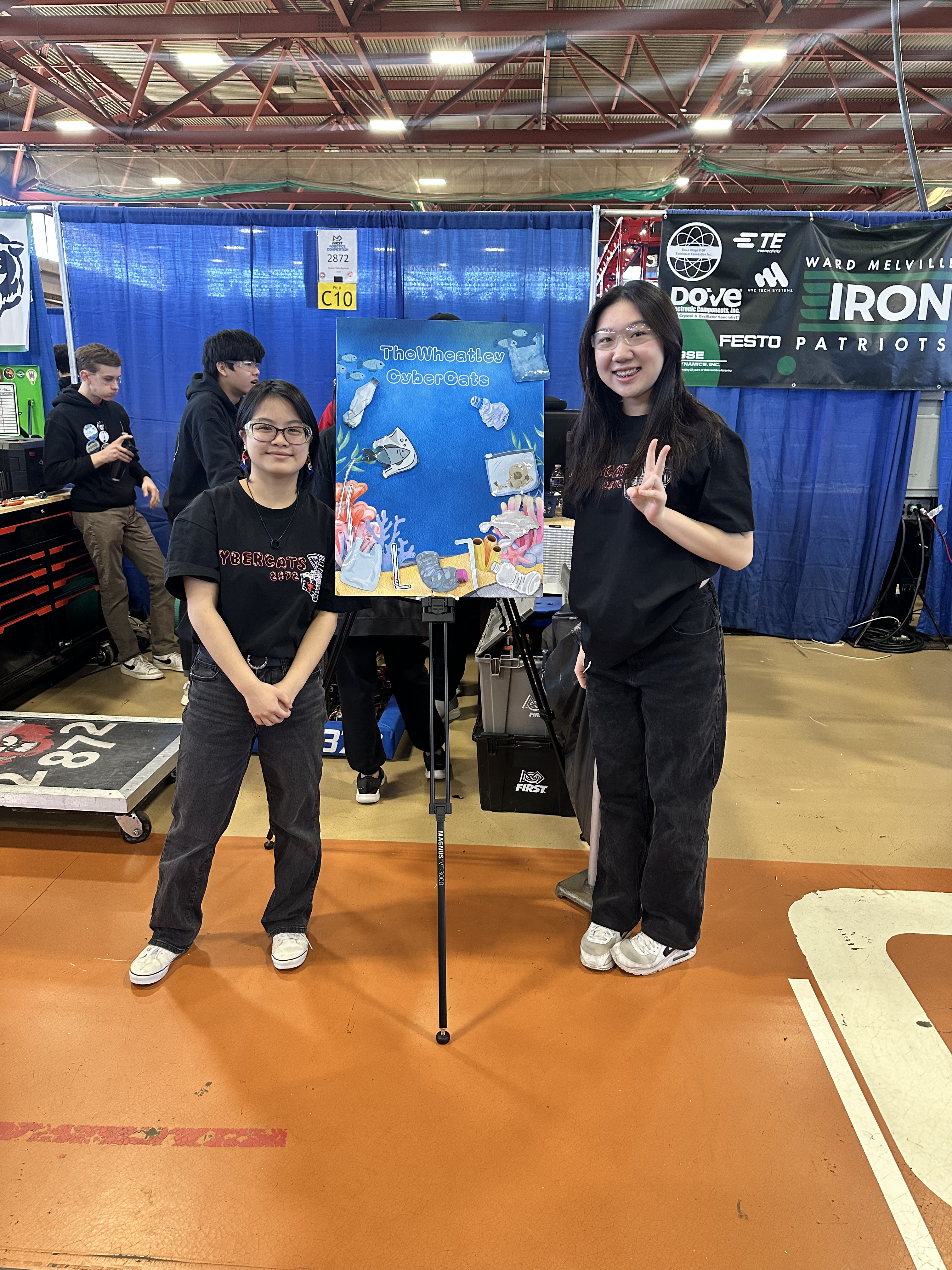 CyberCats team members presenting at FIRST robotics competition event